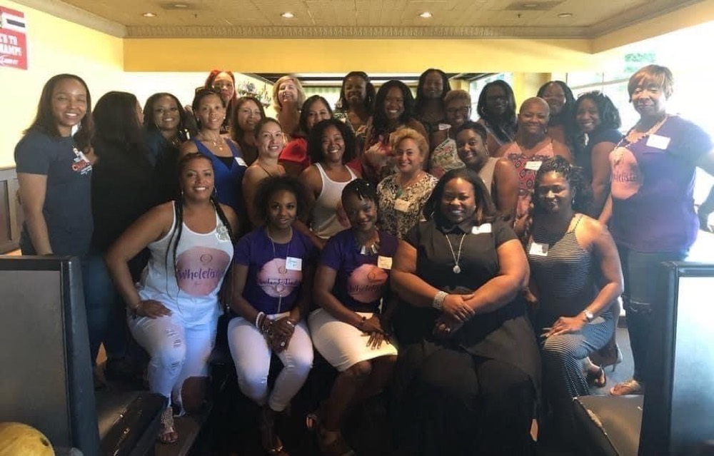 Qiana with members of the Wholelistic for Her community